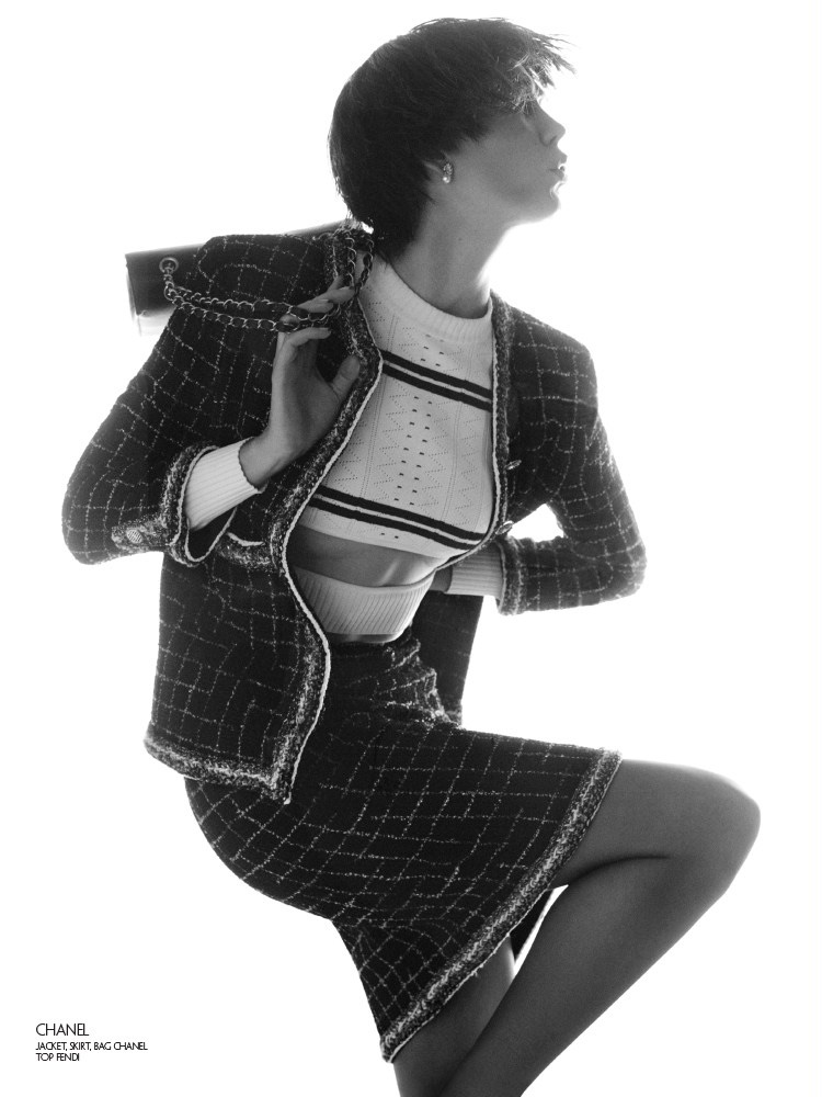 Striking a pose, Karlie Kloss models Chanel tweed jacket and skirt with Fendi top