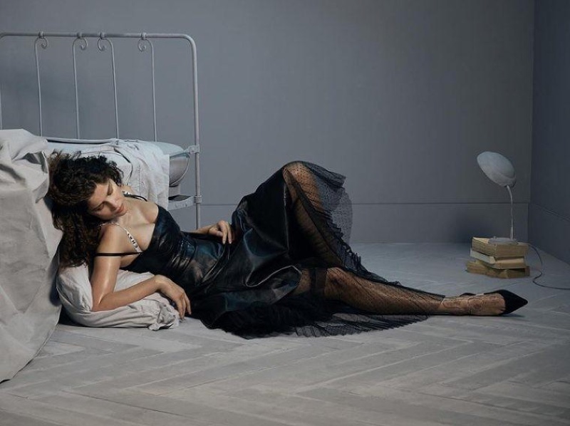 Dressed in black, Laetitia Casta poses in Dior dress