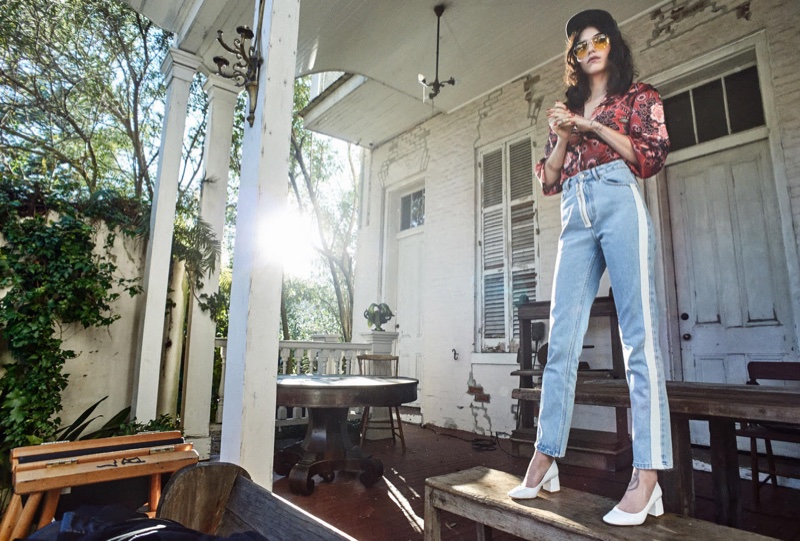 Looking retro chic, Langley Fox Hemingway poses in printed blouse and light wash denim
