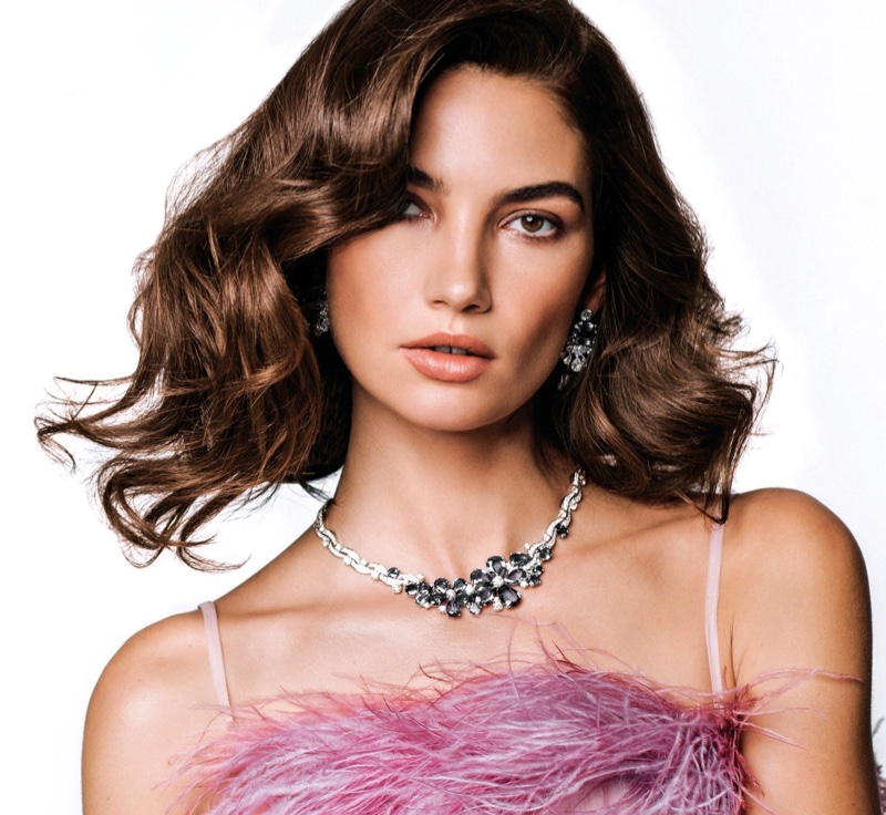 Lily Aldridge poses in feathered top from Prada with Bulgari jewelry