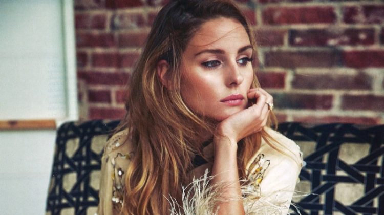 Taking a seat, Olivia Palermo models Prada pajama style top and pants