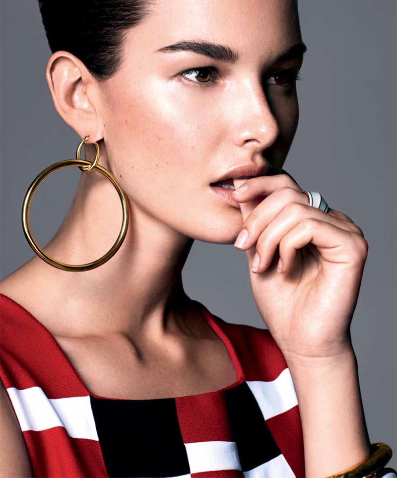 Getting her closeup, Ophelie Guillermand models Azzedine Alaia top with Faraone Mennella earrings. Ring and bracelets by Aurelie Bidermann.