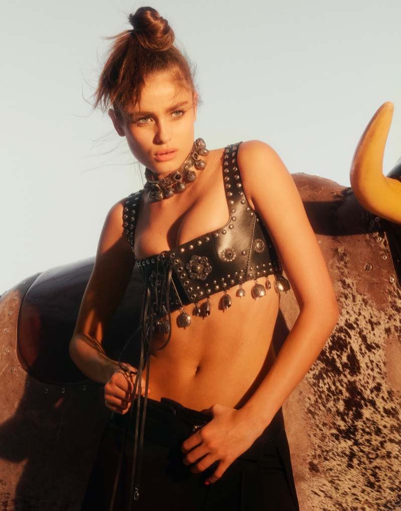 Rocking leather, Taylor Hill poses in Alexander McQueen bralette