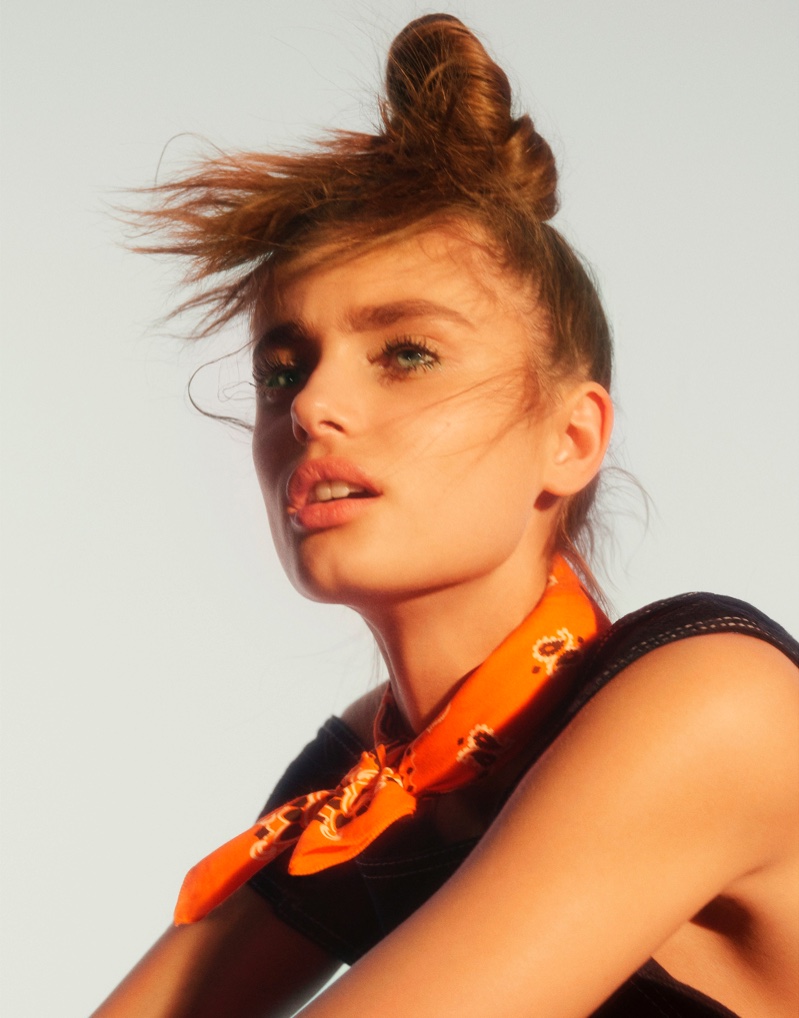 Taylor Hill wears a messy bun with Acne Studios top