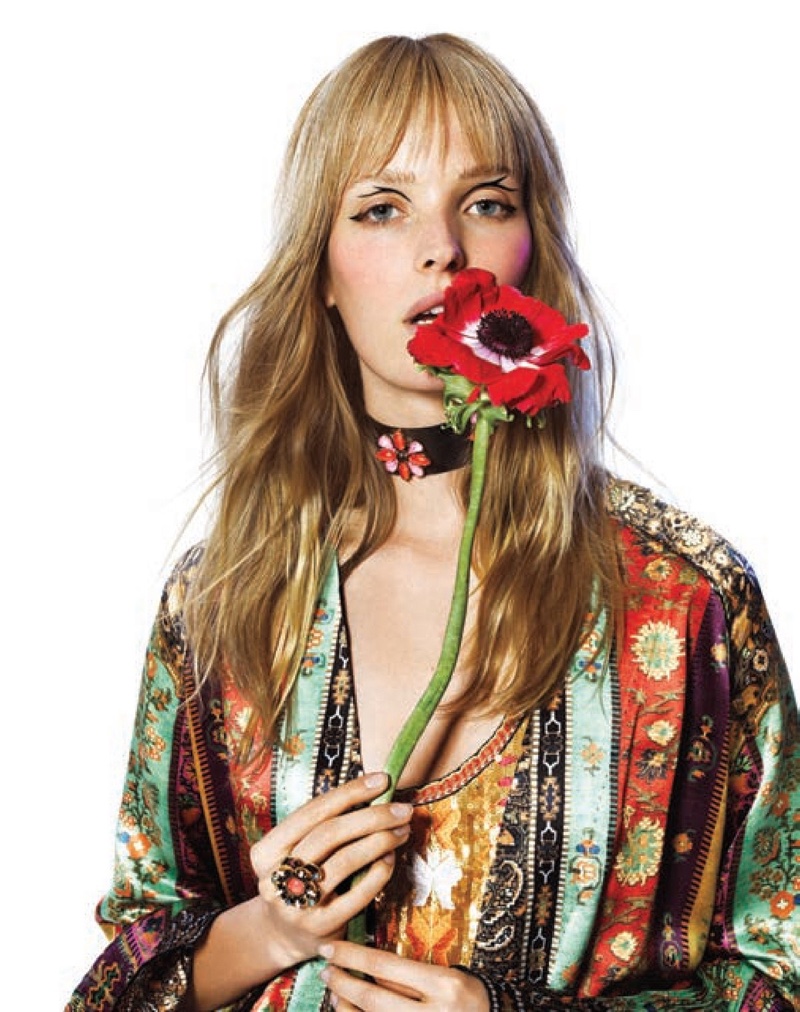 Posing with a flower, Alisa Ahmann models Etro shirt and coat with Erickson Beamon jewelry