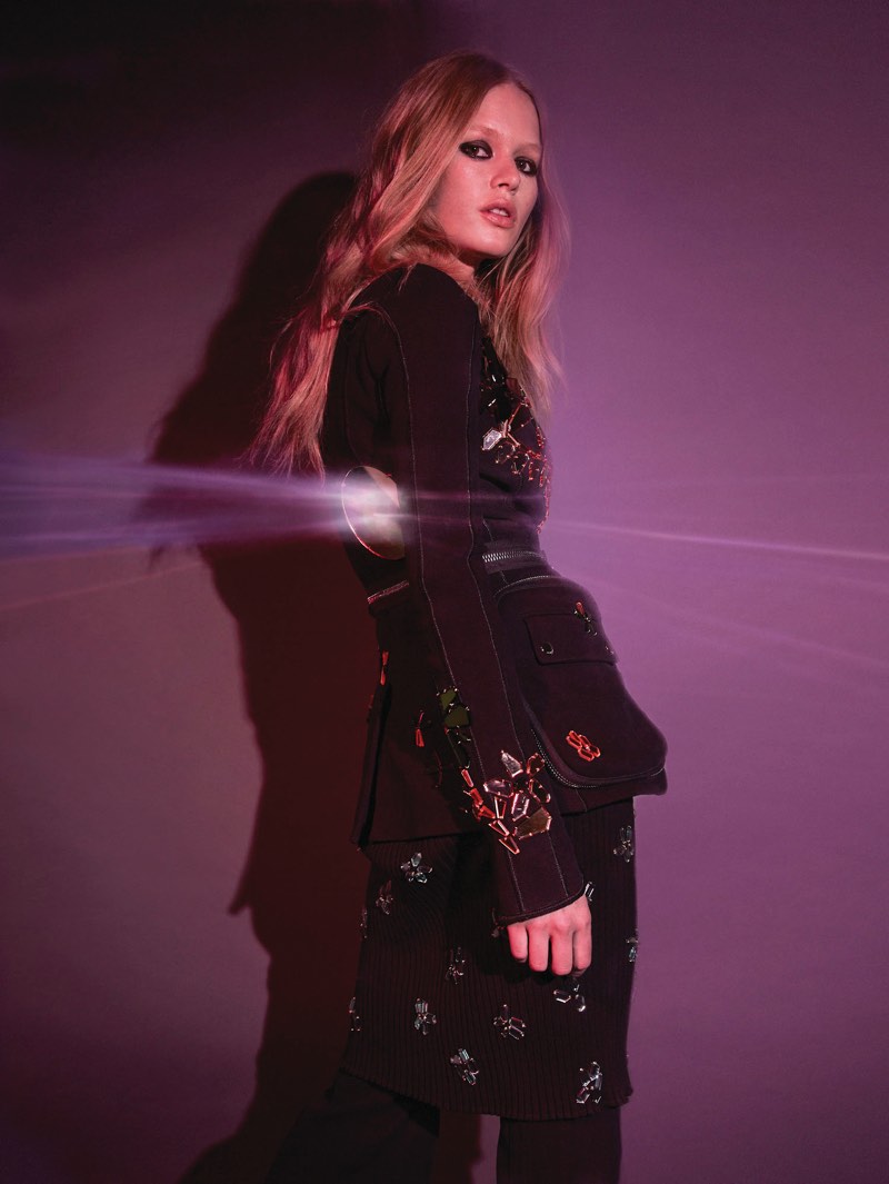 Model Anna Ewers poses in embellished jacket and pants from Givenchy