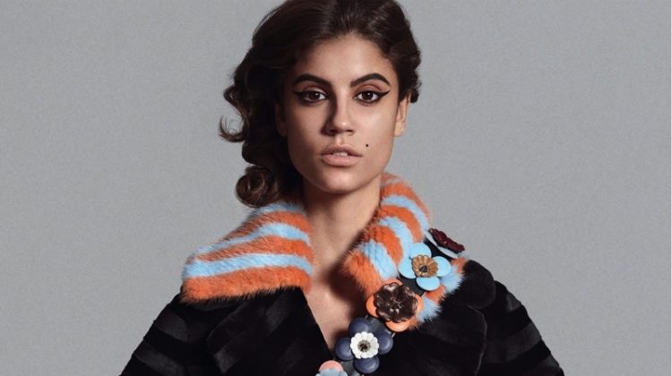 Antonina Petkovic models Fendi mink coat and fringe bag with floral embellished guitar strap