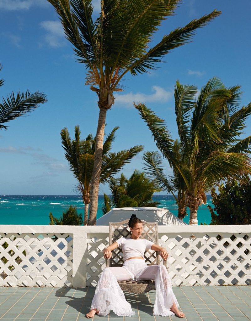 Posing in the Bahamas, Bella Hadid models white t-shirt and flared pants