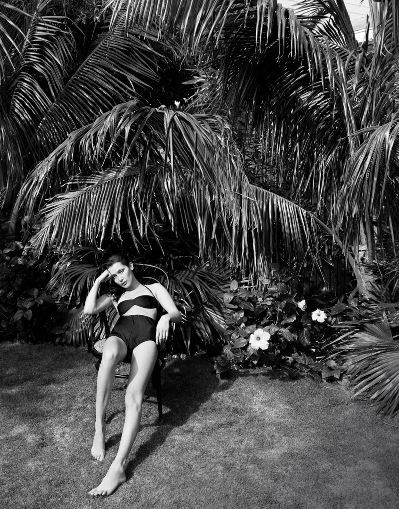 Outdoors, Bella Hadid models black bikini top and high-waist briefs from Miu Miu