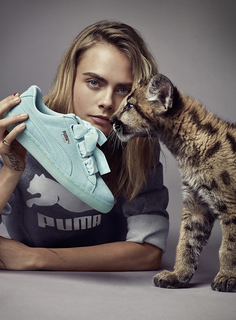 Cara Delevingne poses with PUMA Suede Heart Reset sneaker