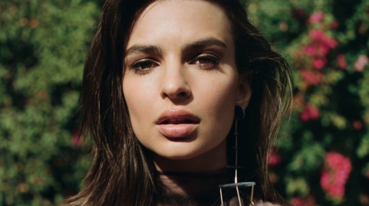 Model Emily Ratajkowski wears strapless bralette with dangling earrings