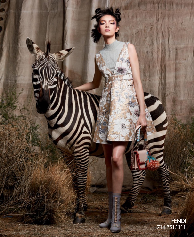 Standing next to a zebra, Fei Fei Sun models Fendi dress, bag and lace-up boots