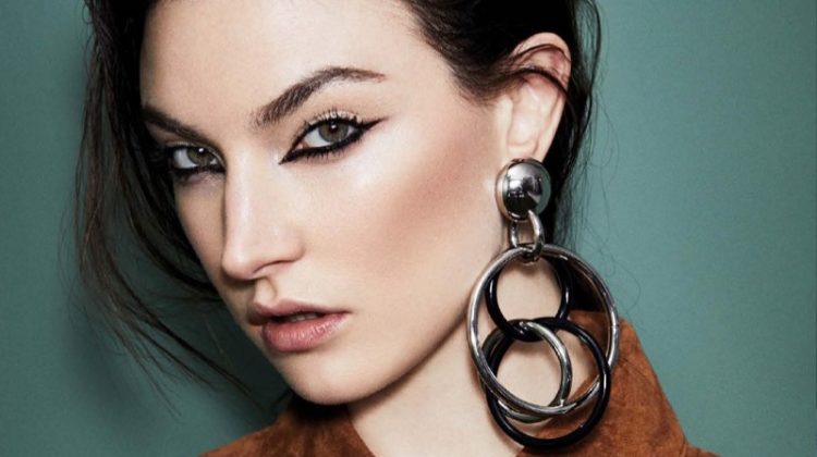 Getting her closeup, Jacquelyn Jablonski models Tod's jacket and Michael Kors Collection earrings