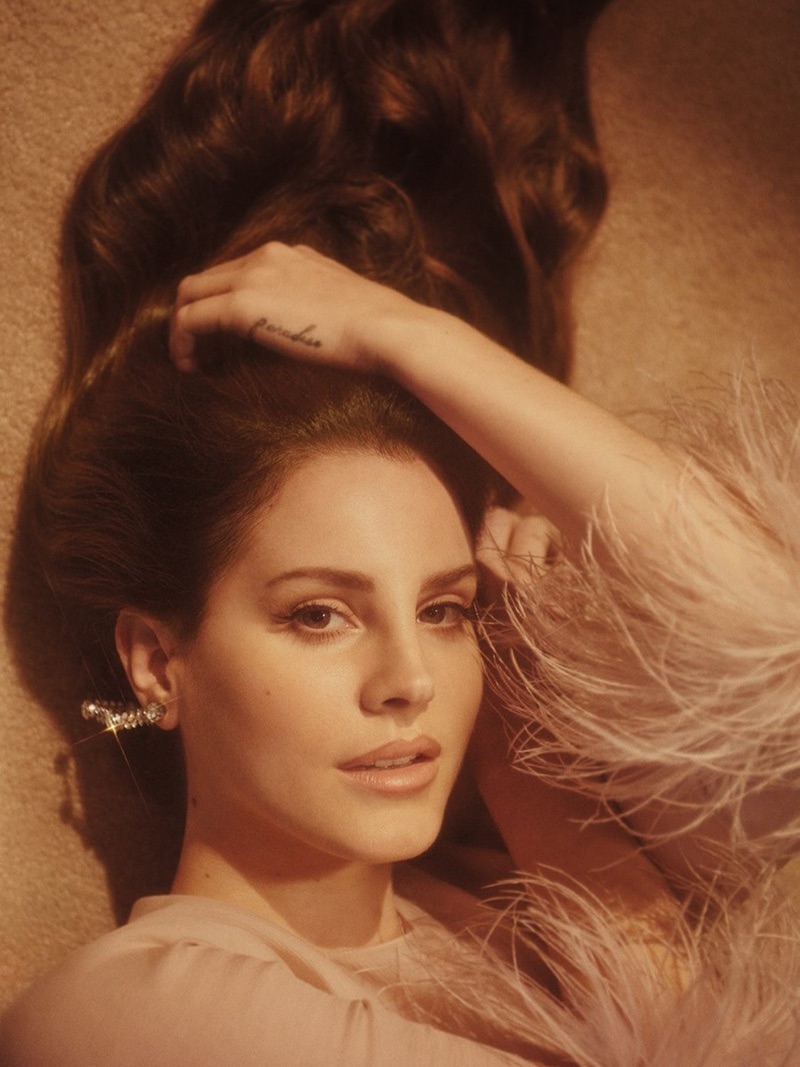 Looking ultra-glam, Lana Del Rey poses in Prada chiffon and ostrich feather dress with Gillian Horsup earrings