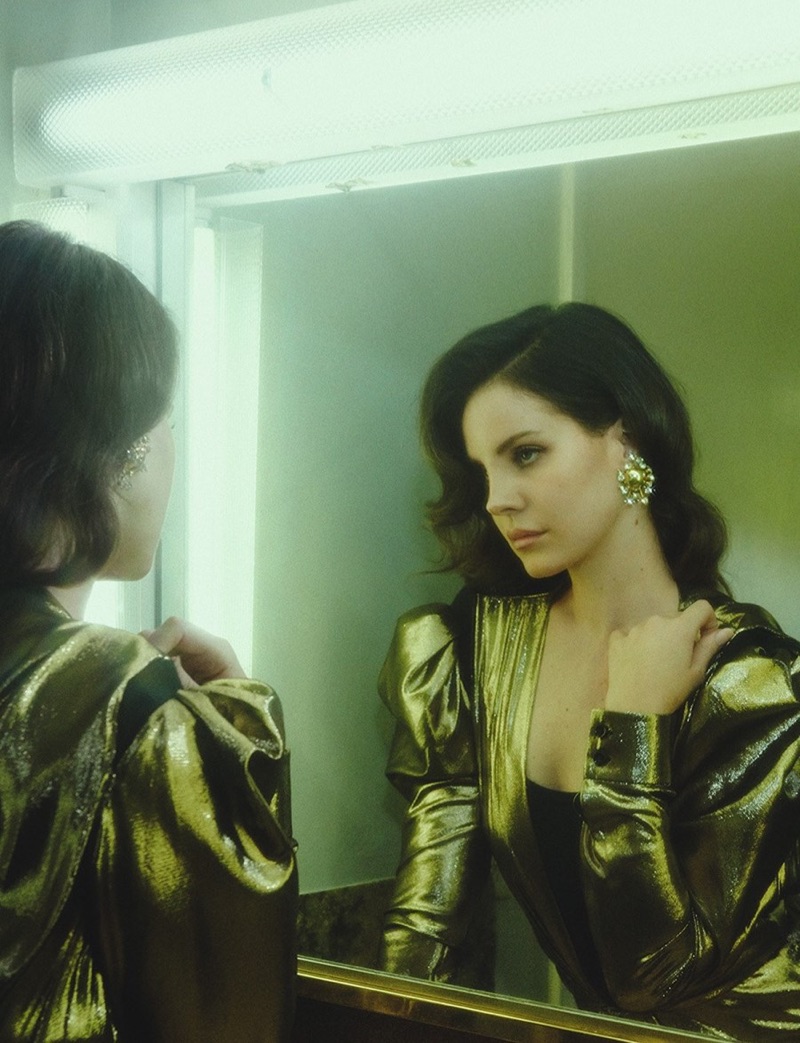 Lana Del Rey poses in Saint Laurent gold lamé dress and Louise Ferdinando earring