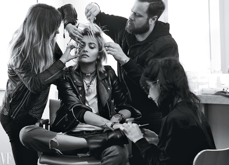 Surrounded by a glam squad, Paris Jackson rocks a leather jacket and ripped denim