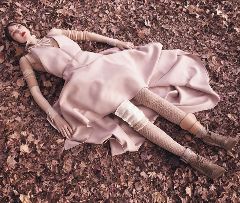 Laying in leaves, Vittoria Ceretti models Valentino dress and Fenty by Puma boots