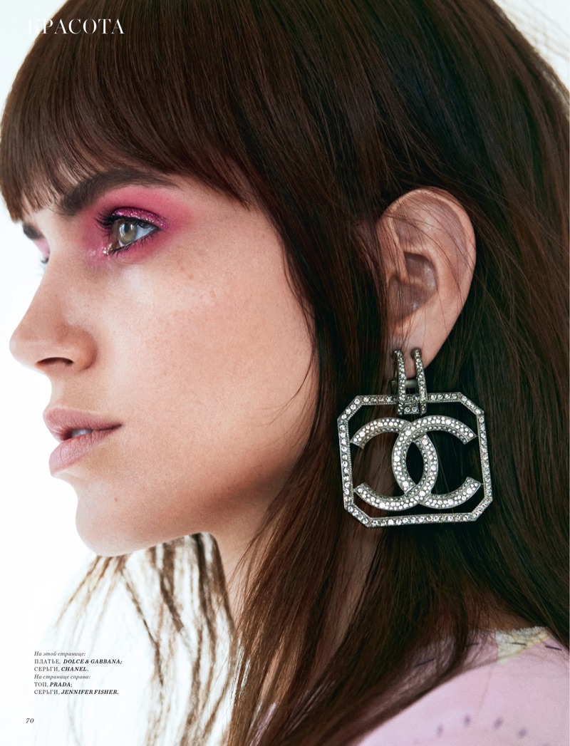 Wearing pink eyeshadow, Amanda Wellsh models Dolce & Gabbana dress with Chanel logo earrings
