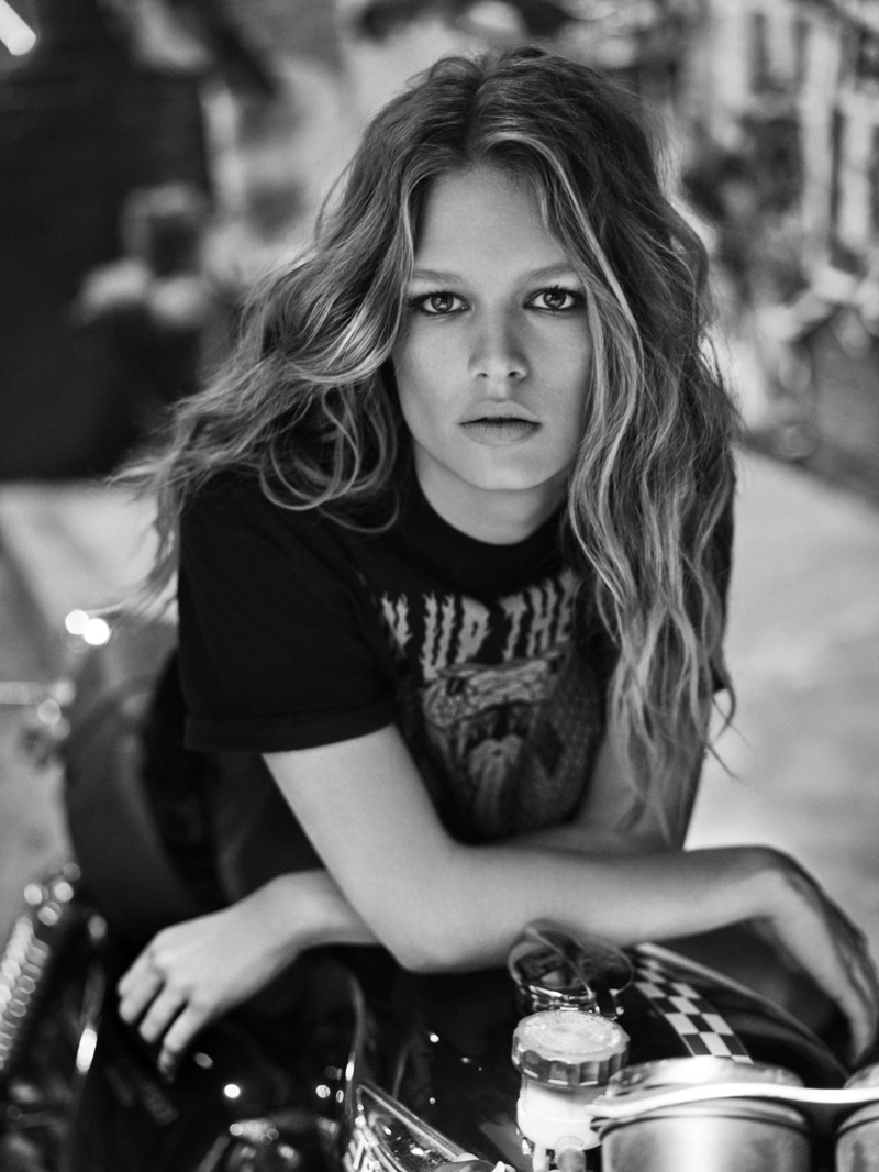 Photographed in black and white, Anna Ewers wears band tee in Colcci's fall-winter 2017 campaign