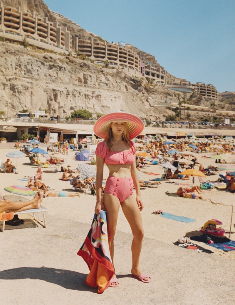 Looking pretty in pink, Anna Ewers wears Lisa Marie Fernandez swimsuit, Missoni hat, Miu Miu sandals and Hermes towel