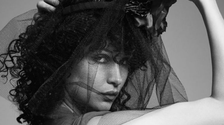 Bella Hadid poses with a curly hairstyle