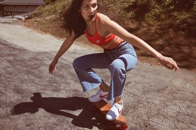 Channeling the 1970's, Bella Hadid wears Nike's Cortez sneaker while skateboarding