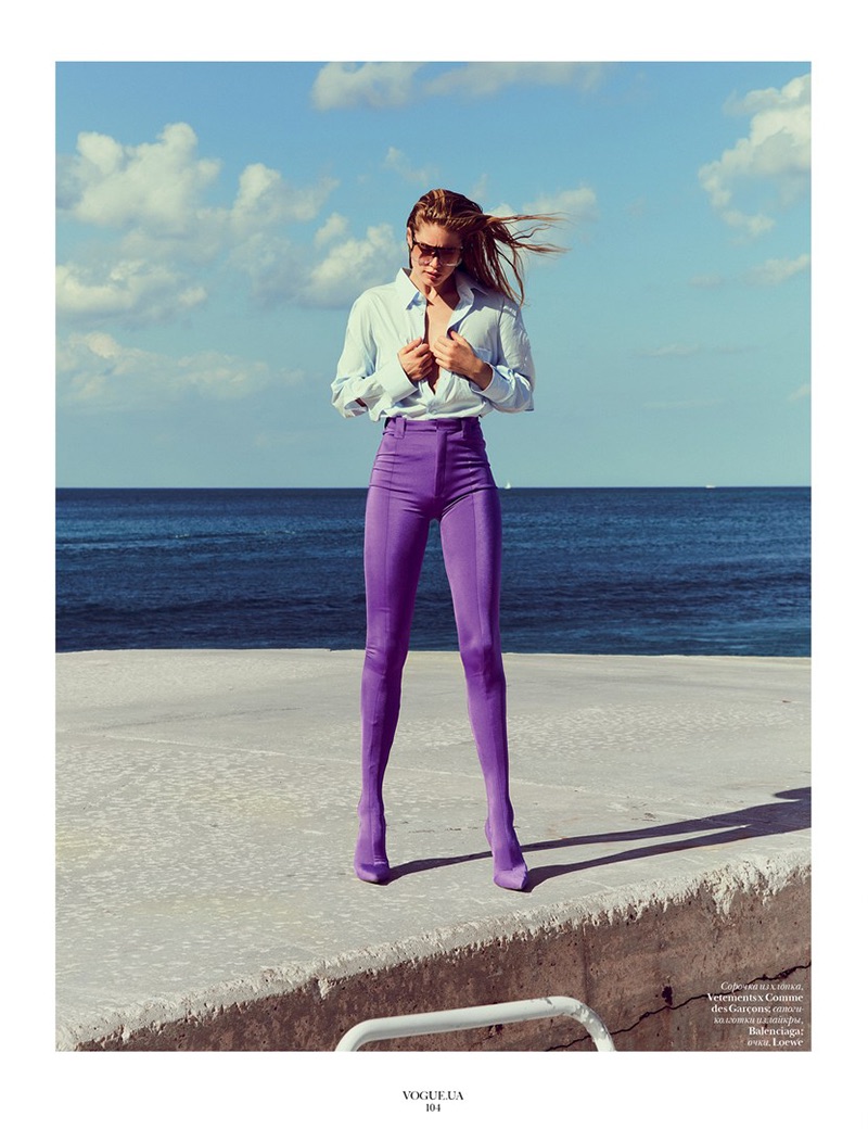Model Doutzen Kroes poses on the beach for the fashion editorial
