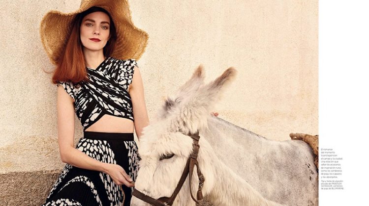 Posing next to a donkey, Kati Nescher models Proenza Schouler top and skirt with Blumarine straw hat