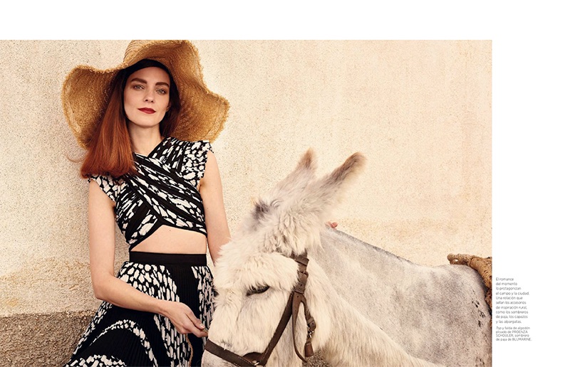 Posing next to a donkey, Kati Nescher models Proenza Schouler top and skirt with Blumarine straw hat