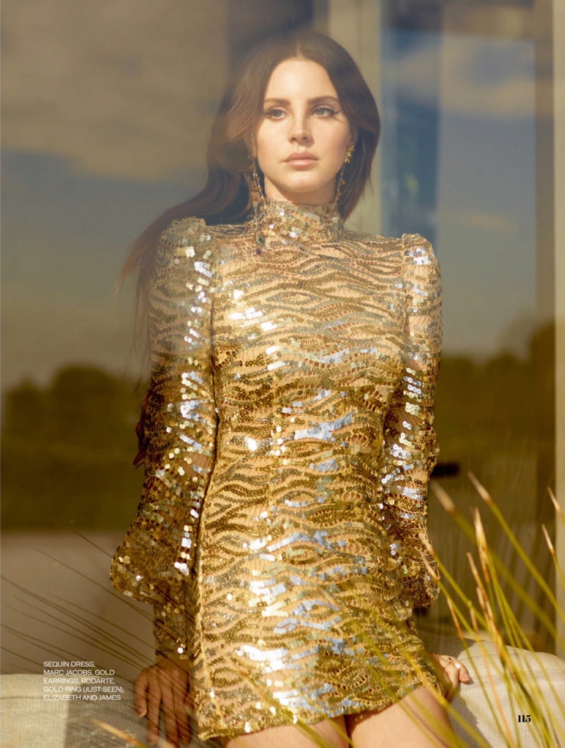 Singer Lana Del Rey models a gold Marc Jacobs sequined dress with Rodarte earrings