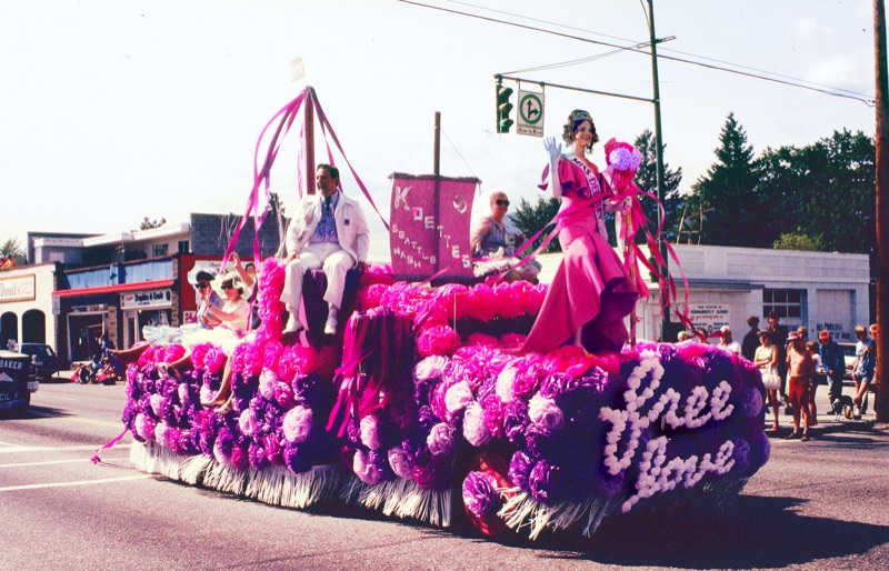 Posing on a parade float, Lana Del Rey wears Christian Siriano dress and Christian Louboutin shoes