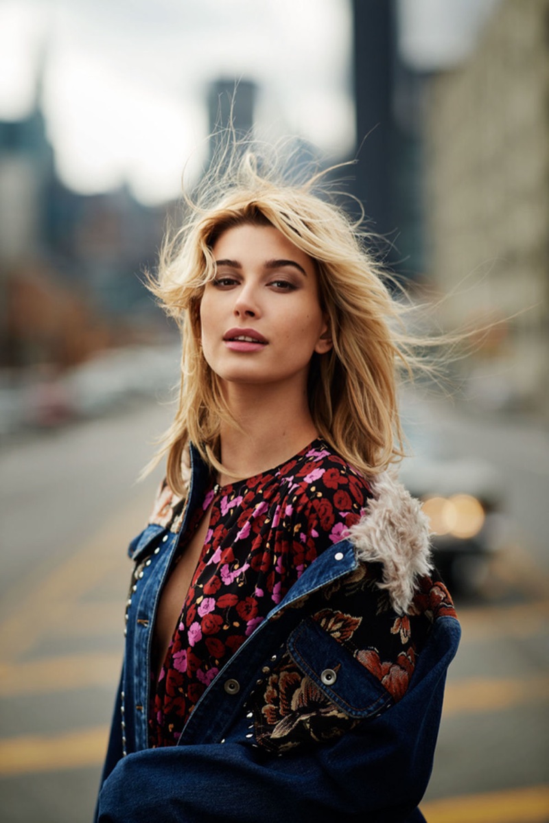 Model Hailey Baldwin wears a Stella McCartney denim jacket and Magda Butrym dress