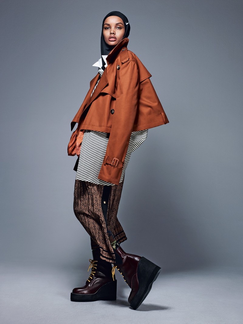 Hilama Aden layers up in Loewe jacket, dress and skirt with Sacai boots