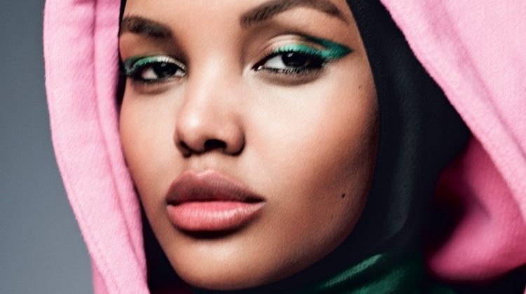 Getting her closeup, Halima Aden wears Gucci sweater and top with green eyeshadow