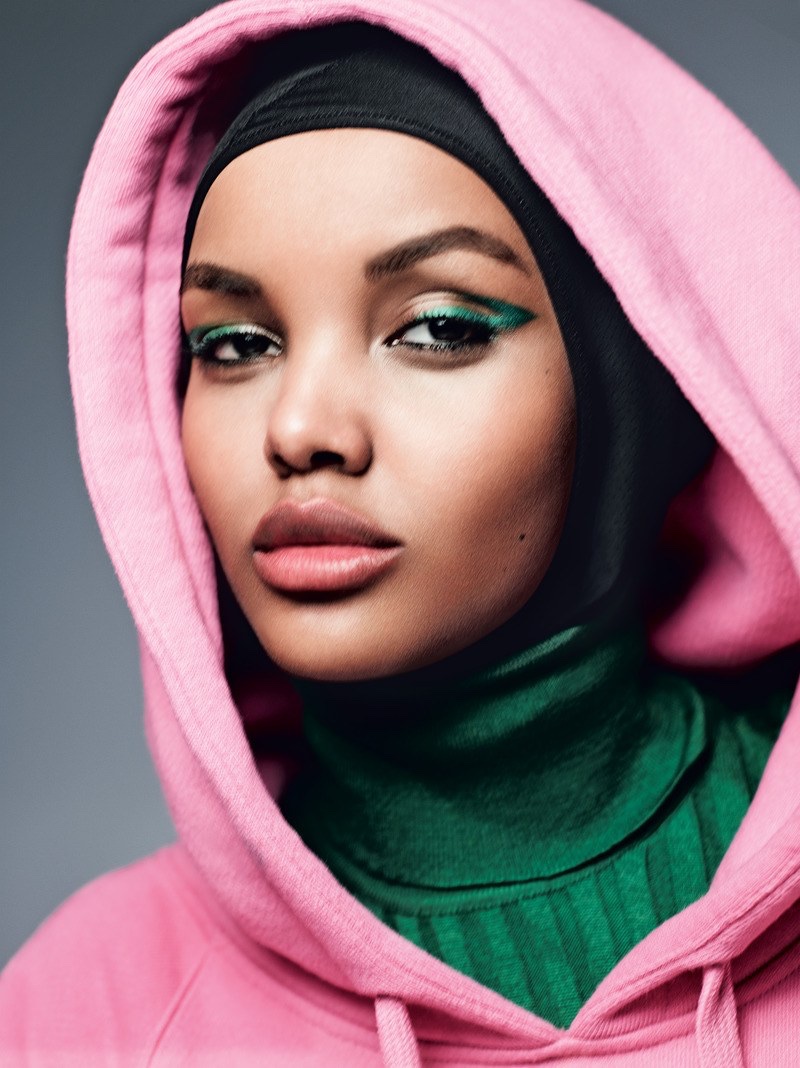 Getting her closeup, Halima Aden wears Gucci sweater and top with green eyeshadow
