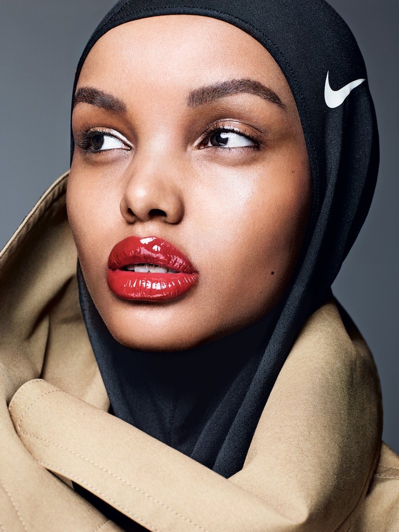 Model Halima Aden poses in Celine trench coat and Nike hijab