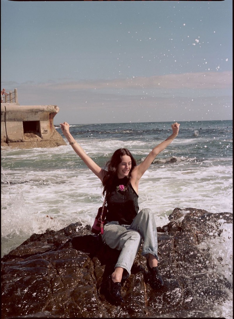 Posing at the beach, Kaya Scodelario wears embroidered top and jeans