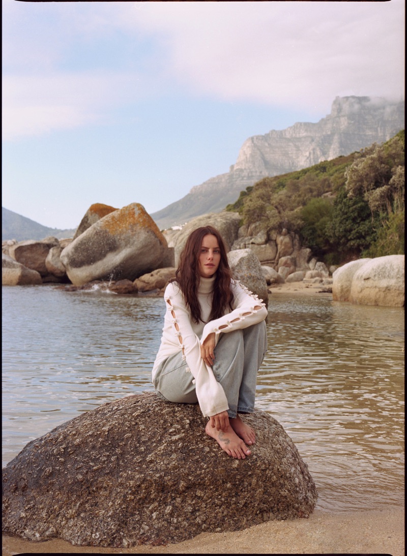 Posing barefoot, Kaya Scodelario wears Chanel sweater