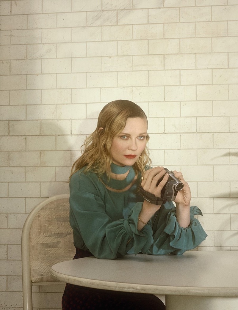 Kirsten Dunst poses with a camcorder wearing a Fendi blouse and Altuzarra skirt