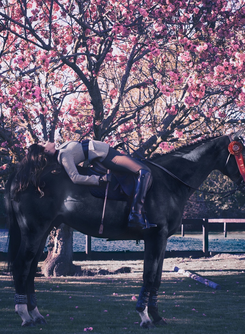 Posing on a horse, Lana Del Rey wears Altuzarra jacket, Vince pants and FRYE boots