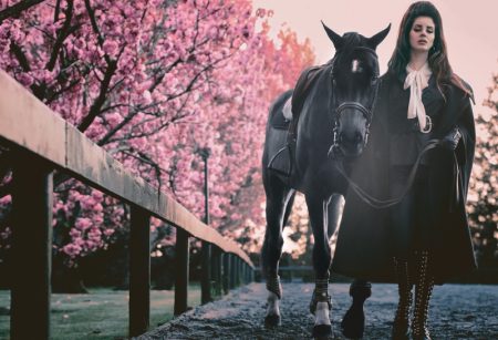 Lana Del Rey Looks Equestrian Chic in V Magazine Lana Del Rey wears DSquared2 cape, Dior jacket, Saint Laurent pants and Vince boots