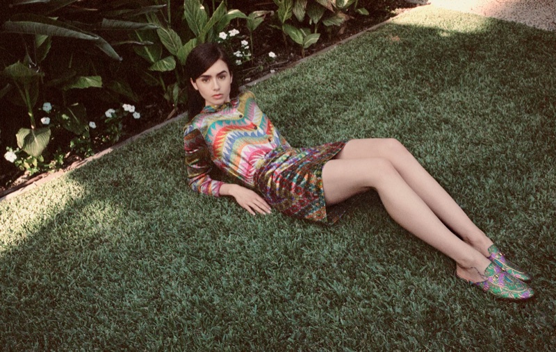 Lounging in grass, Lily Collins poses in Missoni blouse and skirt with Gucci loafers