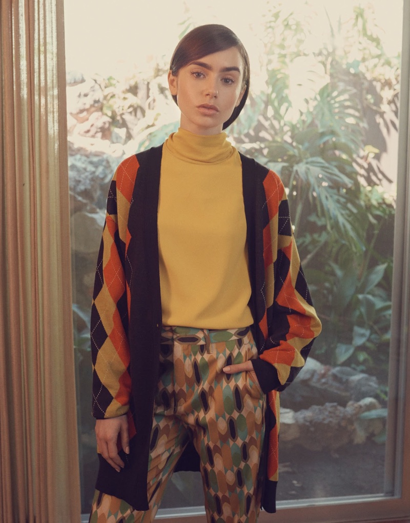 Lily Collins wears Stella McCartney argyle cardigan, Joseph blouse and Prada cropped pants