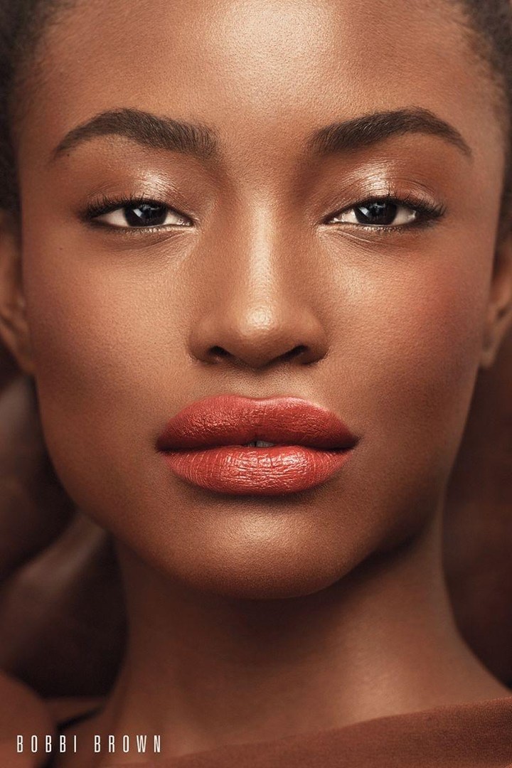 Alicia Burke wears a deep red lip color from Bobbi Brown Cosmetics