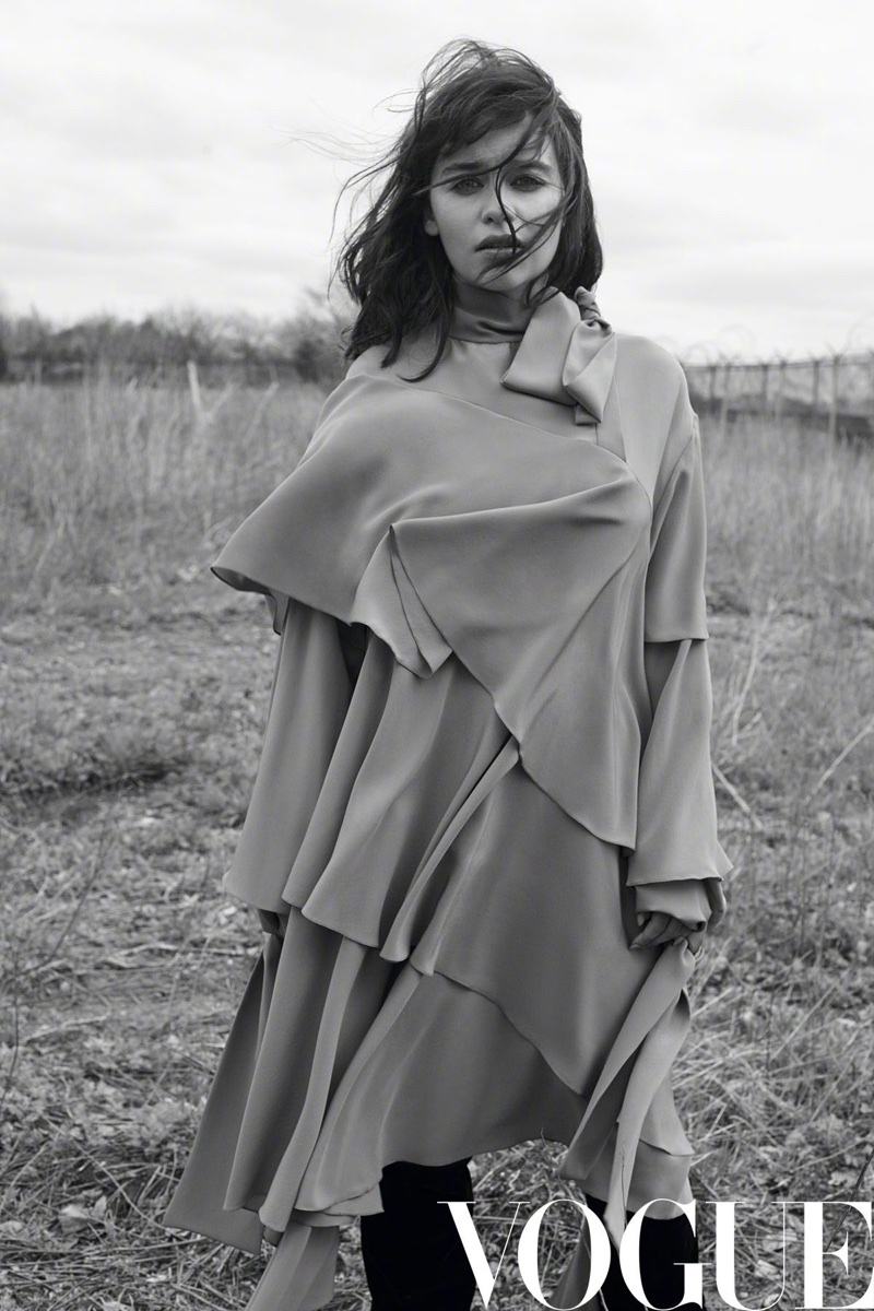 Photographed in black and white, Emilia Clarke wears a ruffled dress