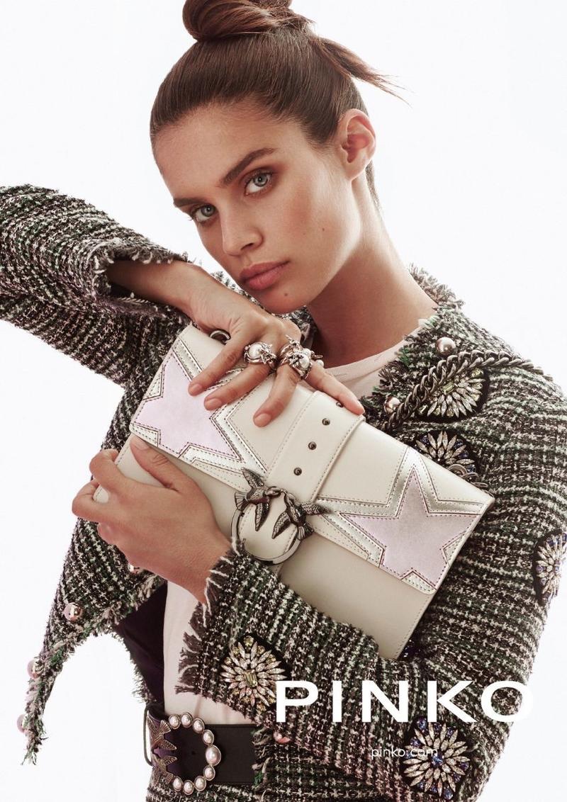 Sara Sampaio poses with a large clutch in Pinko's fall-winter 2017 campaign