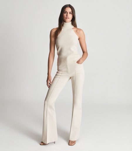 Style Signatures: 7 Wardrobe Staples From REISS Reiss Clem Sleeveless Roll Neck in Cream $245