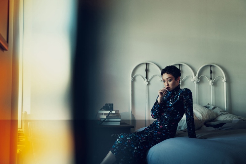 Posing in bed, Ruth Negga wears Prada dress