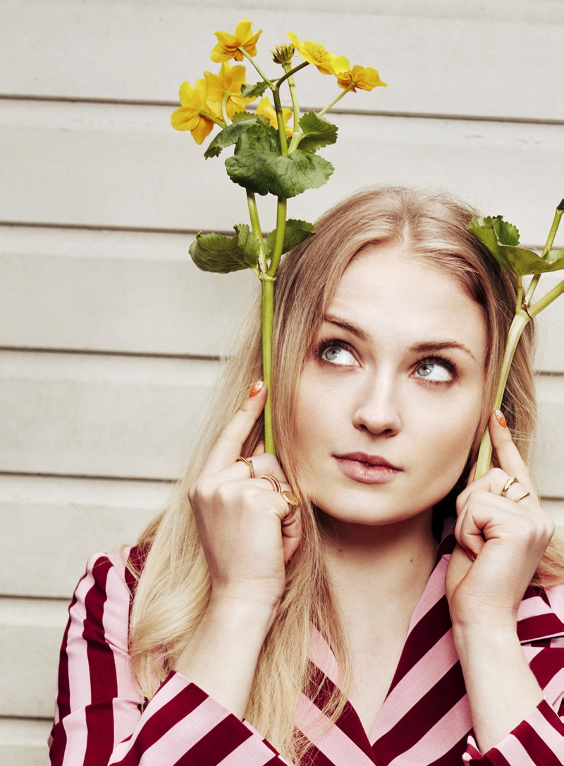 Actress Sophie Turner poses in a striped top