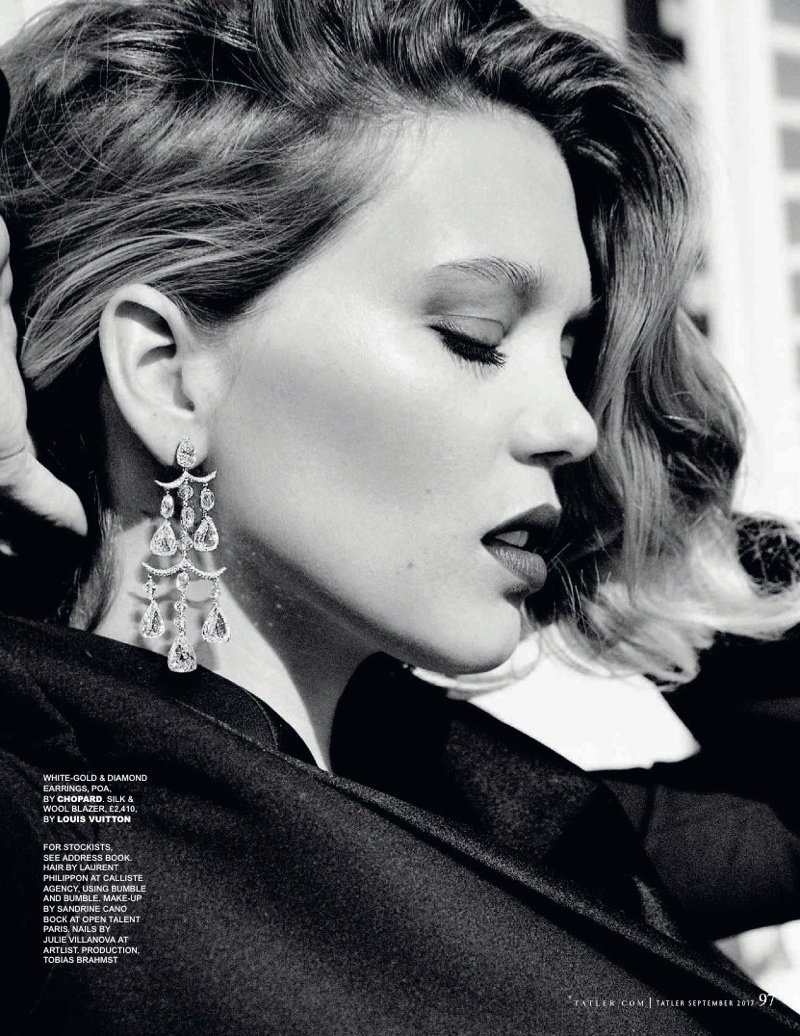Photographed in black and white, Lea Seydoux wears Louis Vuitton blazer and Chopard earrings
